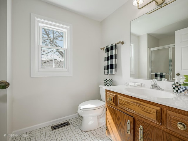 full bathroom featuring visible vents, a stall shower, vanity, baseboards, and toilet
