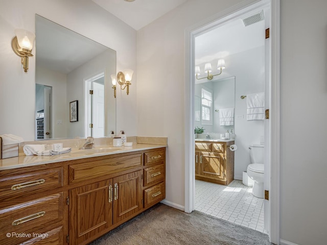 bathroom with visible vents, an inviting chandelier, vanity, toilet, and tile patterned floors