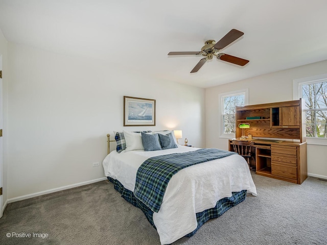 bedroom with a ceiling fan, baseboards, and light carpet