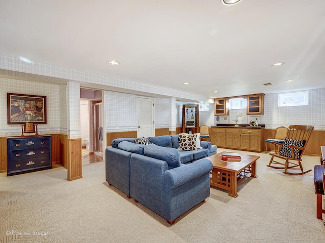 living area featuring light colored carpet, recessed lighting, a wainscoted wall, and wallpapered walls