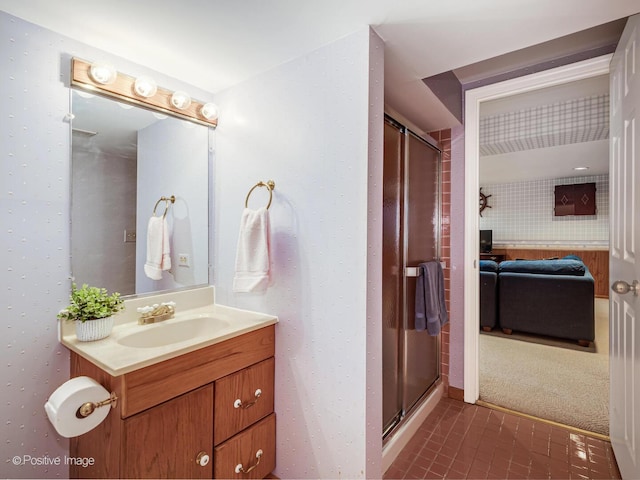 bathroom featuring vanity, tile patterned flooring, and a shower stall