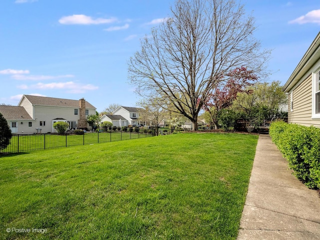 view of yard with fence and a residential view