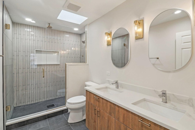 bathroom with a shower stall, toilet, tile patterned floors, and a sink
