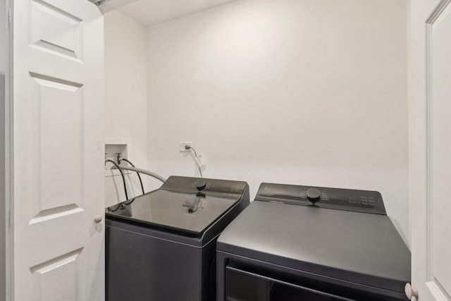 clothes washing area featuring washing machine and dryer and laundry area