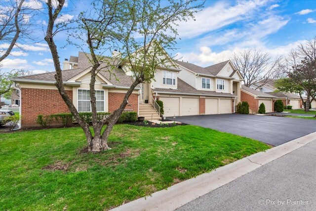 422 Cromwell Cir Unit 2, Bartlett, IL 60103 - multi unit property with brick siding, driveway, a chimney, a garage, and a front lawn