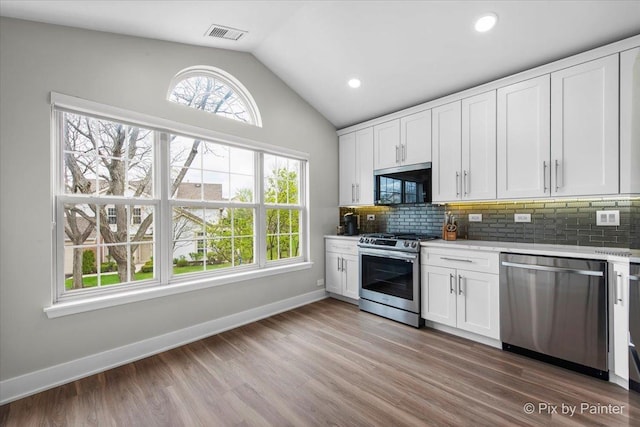 422 Cromwell Cir Unit 2, Bartlett, IL 60103 - kitchen featuring appliances with stainless steel finishes, lofted ceiling, plenty of natural light, white cabinetry, and recessed lighting