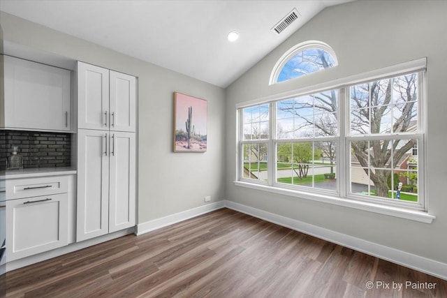 422 Cromwell Cir Unit 2, Bartlett, IL 60103 - unfurnished dining area featuring wood finished floors, baseboards, lofted ceiling, and recessed lighting