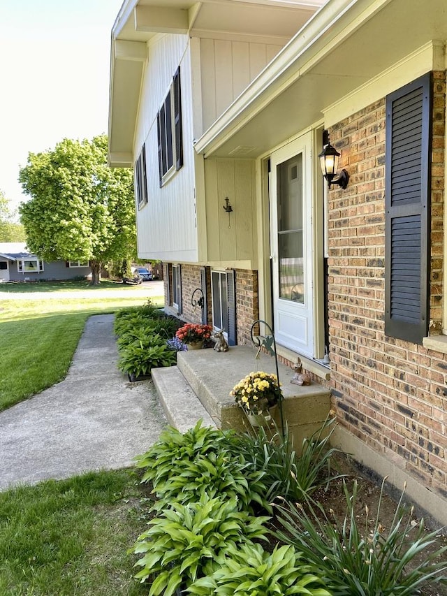 doorway to property featuring brick siding
