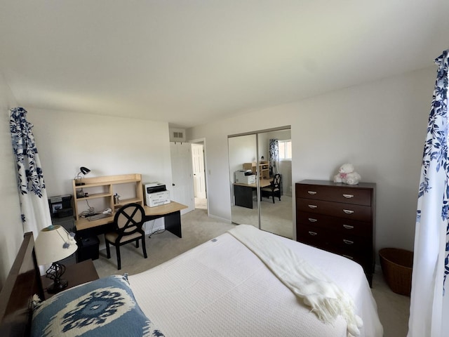 bedroom featuring light colored carpet, visible vents, and a closet