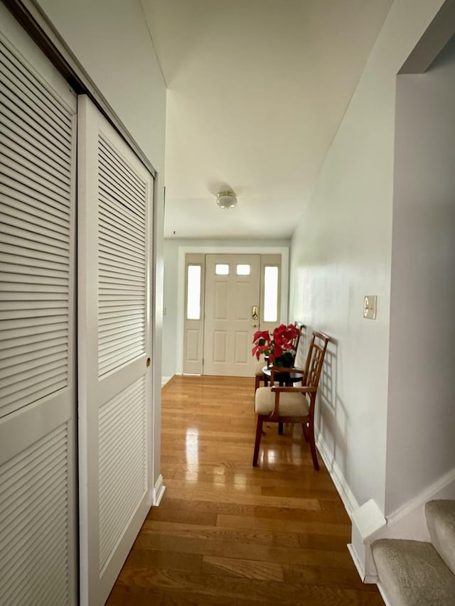 foyer with baseboards and wood finished floors