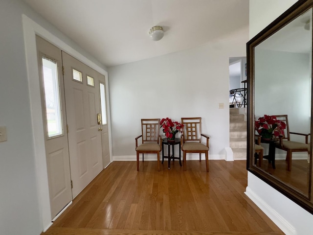 entrance foyer with wood finished floors and baseboards