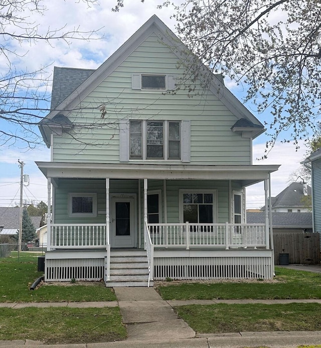 view of front of house with fence and a porch