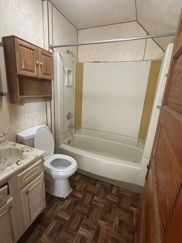 full bath featuring a textured wall, toilet, vanity, and shower / tub combination