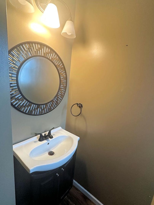 bathroom with vanity and wood finished floors