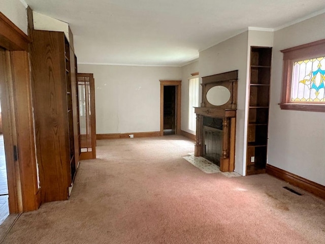 unfurnished living room with a fireplace with flush hearth, carpet floors, and baseboards