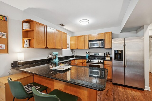 1236 N Campbell Ave Unit G, Chicago, IL 60622 - kitchen featuring a peninsula, open shelves, dark stone counters, stainless steel appliances, and visible vents