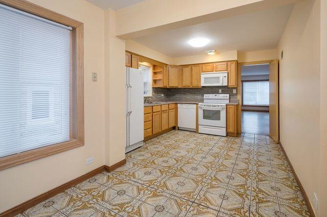 kitchen with open shelves, decorative backsplash, baseboards, and white appliances