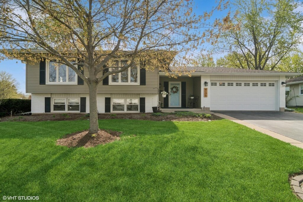 4175 Hudson Dr, Hoffman Estates, IL 60192 - view of front facade featuring an attached garage, driveway, and a front yard