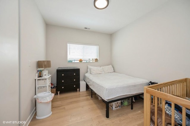 bedroom featuring visible vents and light wood finished floors