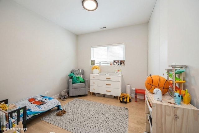 playroom with visible vents and light wood finished floors