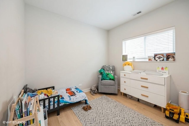 bedroom with visible vents and light wood finished floors