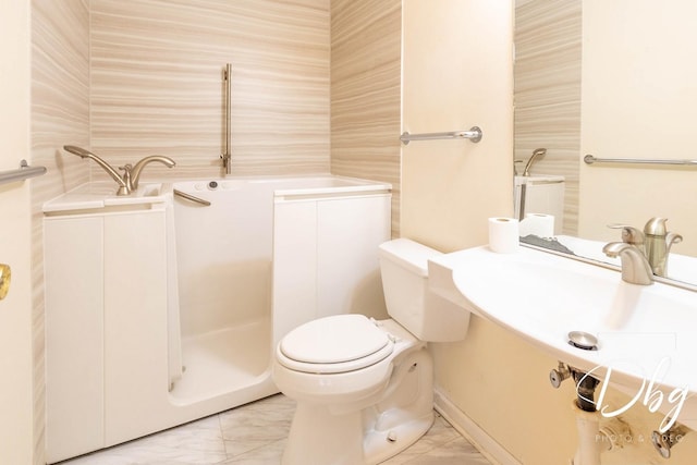 bathroom with marble finish floor and toilet