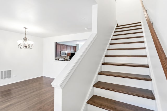 1122 Chelsea Dr, Lake Zurich, IL 60047 - stairway featuring visible vents, baseboards, wood finished floors, and a notable chandelier