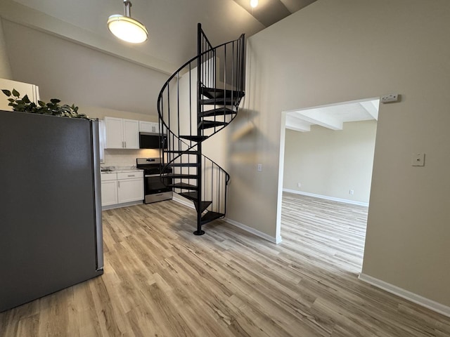 stairs with baseboards and wood finished floors