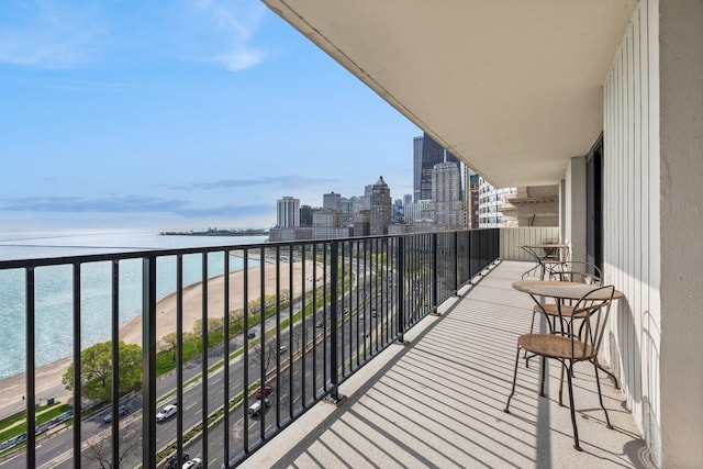 balcony with a view of city and a water view