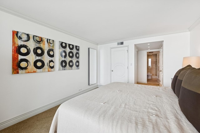 bedroom featuring visible vents, crown molding, ensuite bath, and carpet floors