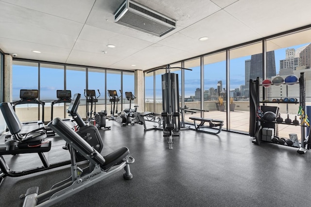 workout area with floor to ceiling windows and a city view