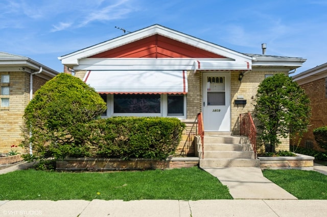3809 N Sayre Ave, Chicago, IL 60634 - shotgun-style home featuring brick siding and a front lawn