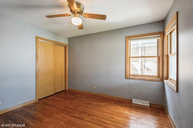 3809 N Sayre Ave, Chicago, IL 60634 - unfurnished bedroom featuring baseboards, visible vents, wood finished floors, and a closet