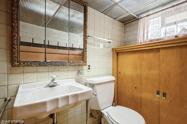 3809 N Sayre Ave, Chicago, IL 60634 - bathroom featuring a sink, tile walls, and toilet