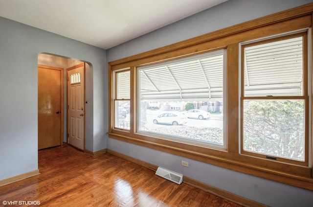 3809 N Sayre Ave, Chicago, IL 60634 - interior space featuring baseboards, arched walkways, wood finished floors, and visible vents