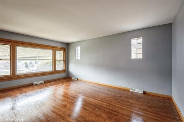 3809 N Sayre Ave, Chicago, IL 60634 - spare room featuring visible vents, a healthy amount of sunlight, and wood finished floors