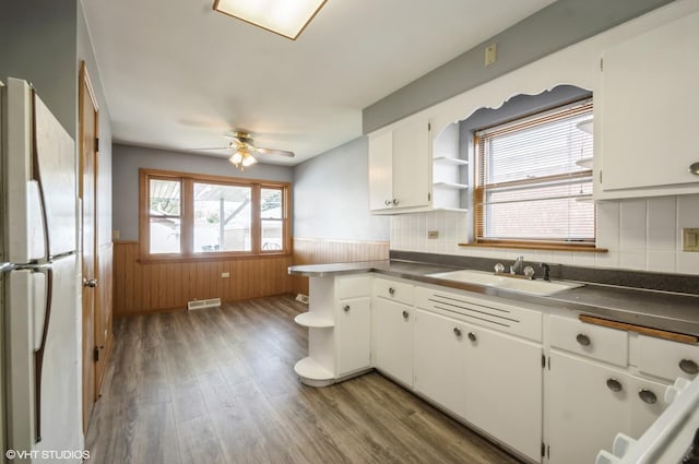 3809 N Sayre Ave, Chicago, IL 60634 - kitchen with open shelves, wainscoting, a sink, freestanding refrigerator, and wood finished floors