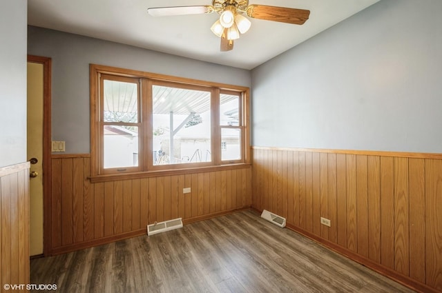 3809 N Sayre Ave, Chicago, IL 60634 - unfurnished room with ceiling fan, visible vents, wood finished floors, and a wainscoted wall