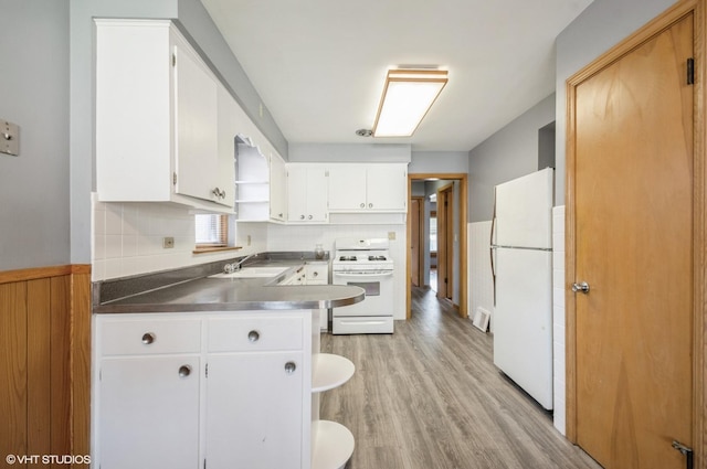 3809 N Sayre Ave, Chicago, IL 60634 - kitchen with white cabinets, a sink, stainless steel countertops, white appliances, and light wood-style floors