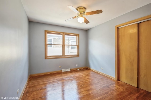 3809 N Sayre Ave, Chicago, IL 60634 - unfurnished bedroom with a ceiling fan, a closet, wood finished floors, and visible vents