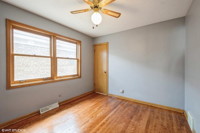 3809 N Sayre Ave, Chicago, IL 60634 - unfurnished room featuring baseboards, visible vents, ceiling fan, and light wood-style floors