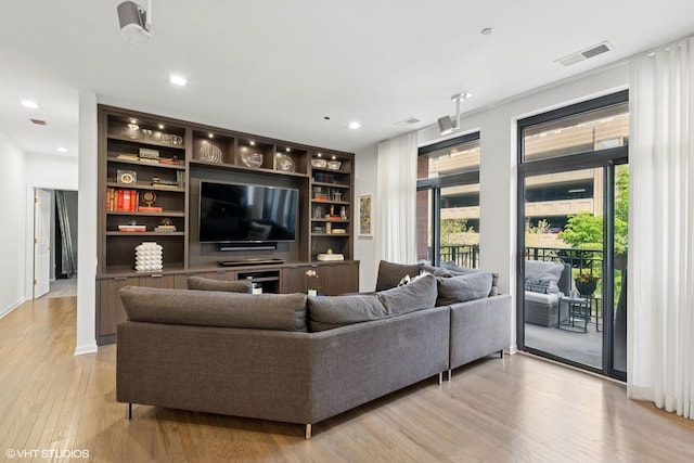 33 W Huron St Unit 309, Chicago, IL 60654 - living area featuring plenty of natural light, light wood-type flooring, built in features, and recessed lighting