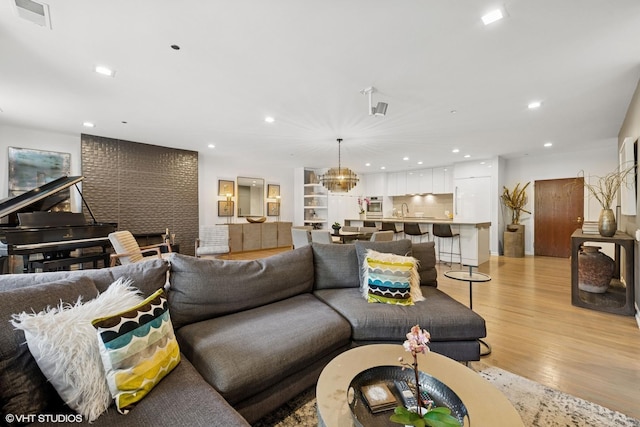 33 W Huron St Unit 309, Chicago, IL 60654 - living room with light wood-style flooring, recessed lighting, and a chandelier