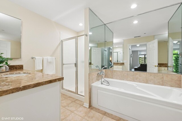 33 W Huron St Unit 309, Chicago, IL 60654 - full bathroom featuring a stall shower, a garden tub, connected bathroom, vanity, and recessed lighting