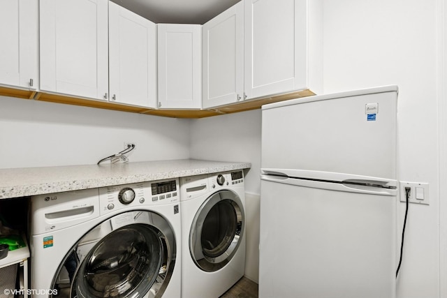 33 W Huron St Unit 309, Chicago, IL 60654 - clothes washing area with washing machine and clothes dryer and cabinet space