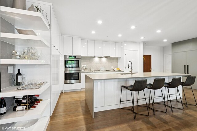 33 W Huron St Unit 309, Chicago, IL 60654 - kitchen with modern cabinets, a sink, light wood-style floors, stovetop, and recessed lighting