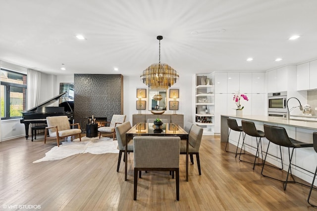 33 W Huron St Unit 309, Chicago, IL 60654 - dining room featuring a chandelier, light wood-type flooring, recessed lighting, and baseboards