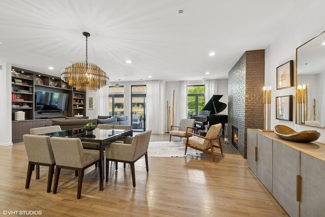 33 W Huron St Unit 309, Chicago, IL 60654 - dining room with a chandelier, light wood-type flooring, a fireplace, recessed lighting, and built in features