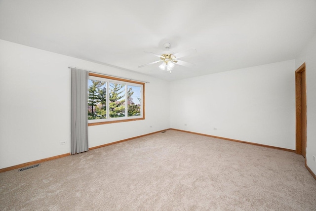spare room with visible vents, ceiling fan, baseboards, and carpet floors