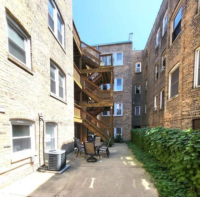 surrounding community featuring stairway, outdoor dining space, and a patio
